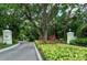 Community entrance featuring lush landscaping and signage at 92 Tall Trees Ct, Sarasota, FL 34232