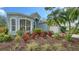 Charming home with a well-manicured front yard, colorful landscaping, and a two-car garage at 92 Tall Trees Ct, Sarasota, FL 34232