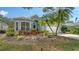 Charming home featuring a two-car garage, vibrant landscaping, and a beautifully maintained front yard at 92 Tall Trees Ct, Sarasota, FL 34232