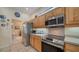 Bright kitchen featuring stainless steel appliances, wood cabinets, and tile backsplash at 92 Tall Trees Ct, Sarasota, FL 34232
