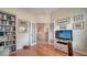 Bright office features French doors, wood floors, and built-in bookshelves at 92 Tall Trees Ct, Sarasota, FL 34232