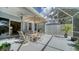 Screened patio with an umbrella, dining set, and access to the home's interior at 92 Tall Trees Ct, Sarasota, FL 34232