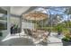 Screened patio with seating area, umbrella, and outdoor grill perfect for entertaining at 92 Tall Trees Ct, Sarasota, FL 34232