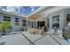 Spacious screened-in patio features an umbrella-shaded dining set and lush landscaping at 92 Tall Trees Ct, Sarasota, FL 34232