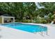 Relax by the community pool with a covered lounge area, perfect for enjoying a cool drink on a sunny day at 92 Tall Trees Ct, Sarasota, FL 34232