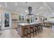 Open concept kitchen with a large island, breakfast bar, and views of the dining area at 1359 Tearose Pl, Sarasota, FL 34239