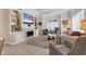 The bright living room features a fireplace with a built-in TV, comfortable seating, and large windows for natural light at 1359 Tearose Pl, Sarasota, FL 34239