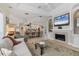 Open-concept living room with a fireplace and built-in TV, seamlessly connected to the kitchen and dining area at 1359 Tearose Pl, Sarasota, FL 34239