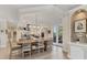 Inviting dining area adjoins a modern kitchen with a central island and stainless steel appliances at 1359 Tearose Pl, Sarasota, FL 34239