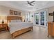 This comfortable bedroom boasts a ceiling fan, natural light, and French doors leading to the outdoor patio at 1359 Tearose Pl, Sarasota, FL 34239