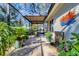 Outdoor patio featuring lush greenery, a water fountain, and a covered dining area perfect for alfresco dining at 1359 Tearose Pl, Sarasota, FL 34239