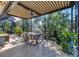 This covered patio features a dining area and is surrounded by lush greenery and a screened enclosure at 1359 Tearose Pl, Sarasota, FL 34239