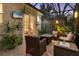 A cozy outdoor patio with comfortable seating, a fire table, and a mounted flatscreen TV at 1359 Tearose Pl, Sarasota, FL 34239