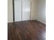 Bedroom with laminate wood flooring and a closet with sliding doors at 1873 University Pl # 135, Sarasota, FL 34235