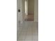 Hallway with tile flooring leading to other rooms, showcasing the home's layout at 1873 University Pl # 135, Sarasota, FL 34235