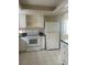 Well-lit kitchen featuring white appliances and ample counter space and white cabinets at 1873 University Pl # 135, Sarasota, FL 34235