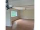 Open living room with hardwood flooring and neutral wall color. Ceiling fan installed at 1873 University Pl # 135, Sarasota, FL 34235