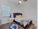This bedroom showcases a plush bed, ample natural light, and wood floors for a cozy retreat at 2006 Red Lake Run, Bradenton, FL 34211