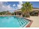 Community pool with inviting steps, covered pavilion, and poolside seating for relaxation at 2006 Red Lake Run, Bradenton, FL 34211