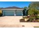 Charming single-story home with a well-manicured lawn, featuring a two-car garage and beautiful tropical landscaping at 2006 Red Lake Run, Bradenton, FL 34211