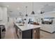 Open-concept kitchen with a large center island, modern appliances, and seamless flow into the living area at 2006 Red Lake Run, Bradenton, FL 34211