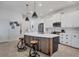 Modern kitchen features a large center island with bar seating and white cabinetry at 2006 Red Lake Run, Bradenton, FL 34211