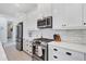 Stylish kitchen featuring stainless steel appliances, white cabinets, and a subway tile backsplash at 2006 Red Lake Run, Bradenton, FL 34211