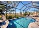 The screened-in pool area features a tiled pool, patio furniture, and a relaxing outdoor space at 2006 Red Lake Run, Bradenton, FL 34211