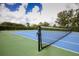Well-maintained tennis court with a blue and green surface, perfect for recreation and sports at 2006 Red Lake Run, Bradenton, FL 34211