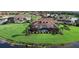 Aerial view of home with screened-in pool, lush landscaping, and serene water views at 273 Portofino Dr, North Venice, FL 34275