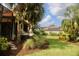 Enjoy lush landscaping and relaxation in this backyard featuring a hammock between palm trees at 273 Portofino Dr, North Venice, FL 34275