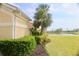Green backyard with meticulously manicured landscaping and a view of the lake at 273 Portofino Dr, North Venice, FL 34275