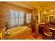 Luxurious bathroom with soaking tub, walk-in shower, granite counters, and elegant fixtures at 273 Portofino Dr, North Venice, FL 34275