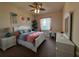 Cozy bedroom with bright decor, a ceiling fan, and lots of natural light from the window at 273 Portofino Dr, North Venice, FL 34275