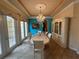 Stylish dining room features a designer chandelier, large windows, and access to a patio at 273 Portofino Dr, North Venice, FL 34275