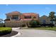 Stunning two-story home featuring a red tile roof, three-car garage, and beautiful landscaping at 273 Portofino Dr, North Venice, FL 34275