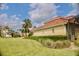 Lush lawn and landscaping surrounding the home's exterior with a view of the lake at 273 Portofino Dr, North Venice, FL 34275