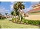 A view of a community with sidewalks, lush green lawns and landscaping in a serene community at 273 Portofino Dr, North Venice, FL 34275