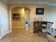 Spacious hallway with tiled floors, archways, and decorative artwork that provides an elegant transition between rooms at 273 Portofino Dr, North Venice, FL 34275