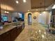 Spacious kitchen with a center island, granite countertops, and stainless steel fixtures at 273 Portofino Dr, North Venice, FL 34275