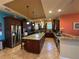Gourmet kitchen with a large island, stainless steel appliances, and dark wood cabinets at 273 Portofino Dr, North Venice, FL 34275
