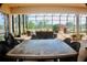 Spacious lanai features an outdoor dining area and comfortable seating overlooking the pool and lake at 273 Portofino Dr, North Venice, FL 34275