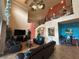 Open-concept living room with high ceilings, leather seating, and a view of the upstairs landing at 273 Portofino Dr, North Venice, FL 34275