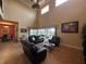 Open living room with a soaring ceiling, tile floors, and large windows overlooking the pool at 273 Portofino Dr, North Venice, FL 34275