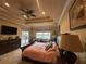 Comfortable main bedroom with a tray ceiling, a private patio and walk out doors at 273 Portofino Dr, North Venice, FL 34275