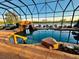 Beautiful screened pool with rock waterfall feature and view of the lake at 273 Portofino Dr, North Venice, FL 34275