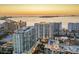 Stunning aerial view of waterfront high-rise buildings at sunset, overlooking the city and the water at 301 Quay Commons # 1411, Sarasota, FL 34236