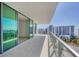 Expansive balcony with glass railings offering stunning views of the city skyline and waterfront at 301 Quay Commons # 1411, Sarasota, FL 34236
