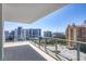A large outdoor balcony has views of city buildings and ocean at 301 Quay Commons # 1411, Sarasota, FL 34236