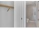 View through doorway to bath with glass shower and commode. Closet with shelving on the left at 301 Quay Commons # 1411, Sarasota, FL 34236